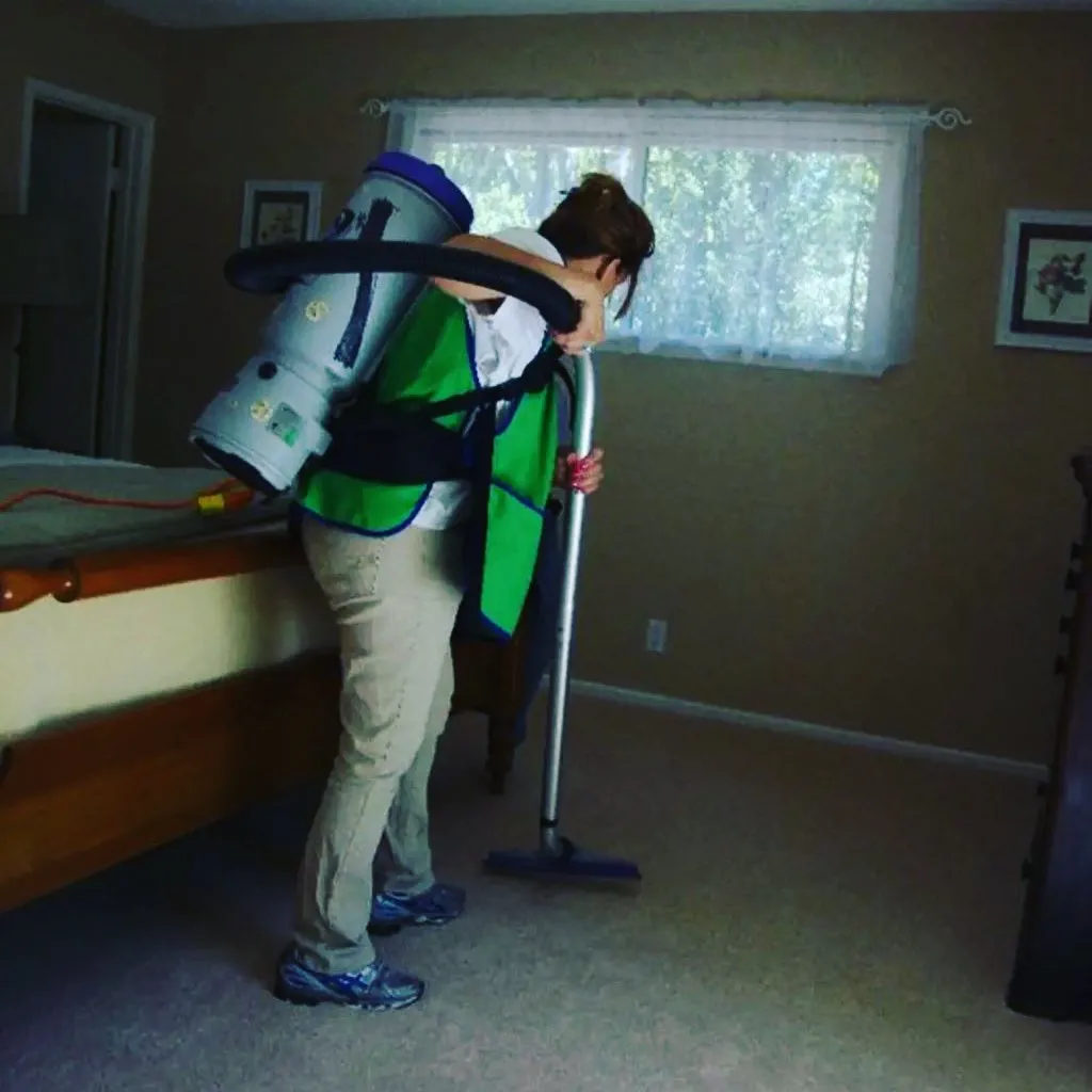 person vacuuming room